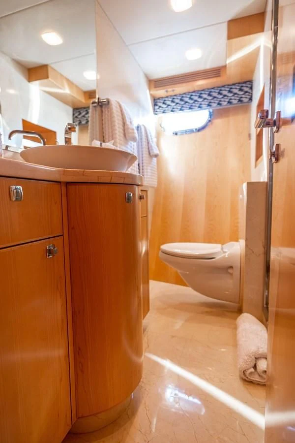 a bathroom with a toilet and sink aboard SALVATORE II Yacht for Sale