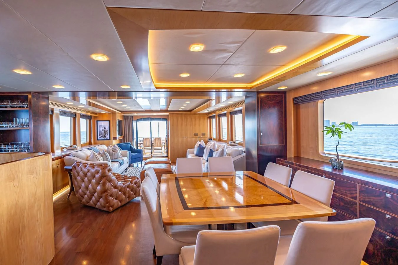 a living room with a table and chairs aboard SALVATORE II Yacht for Sale