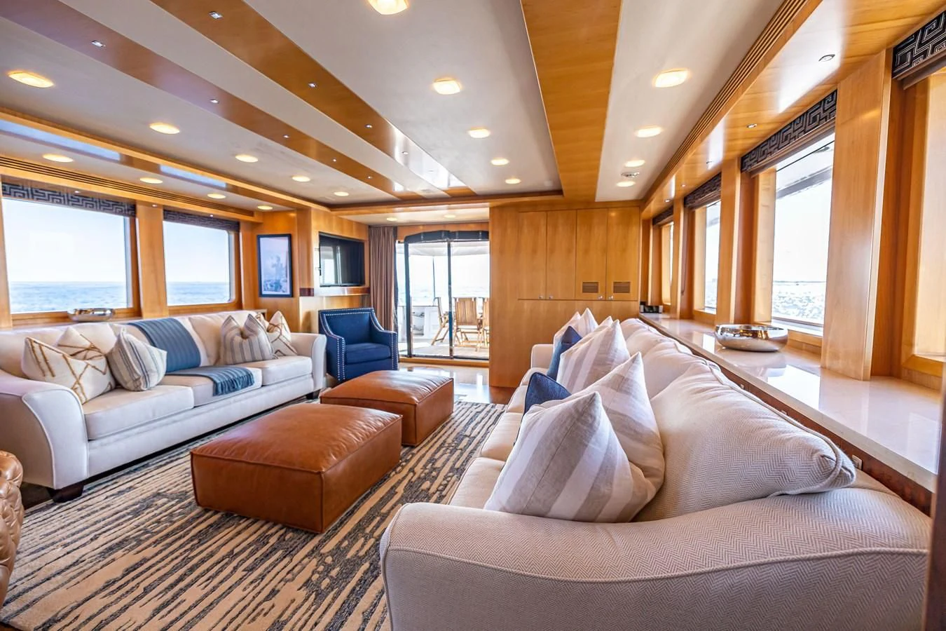 a living room with a couch and a large window aboard SALVATORE II Yacht for Sale