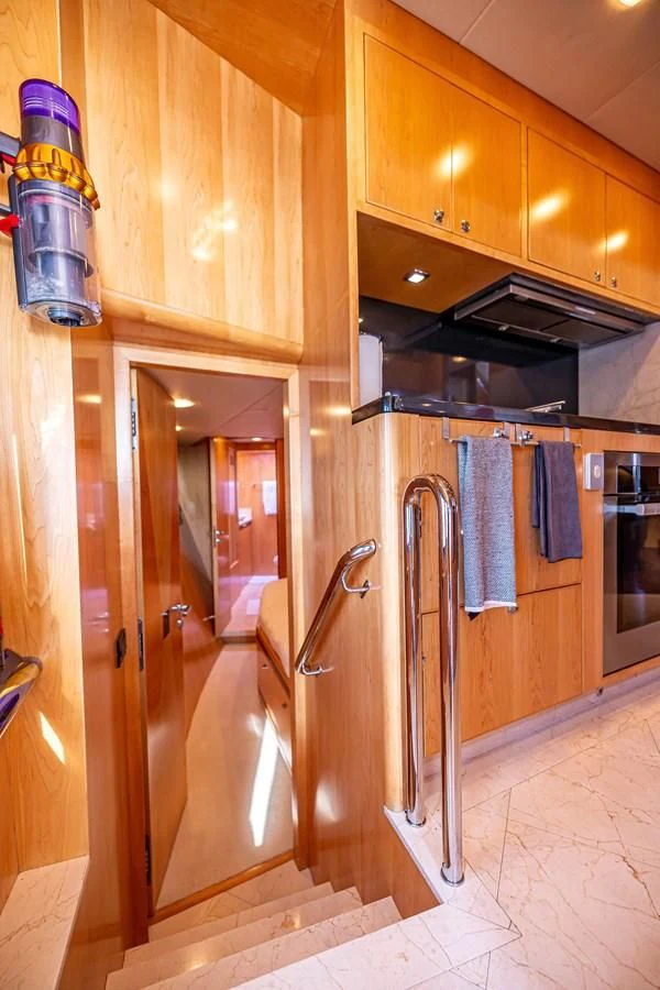 a kitchen with wooden cabinets aboard SALVATORE II Yacht for Sale