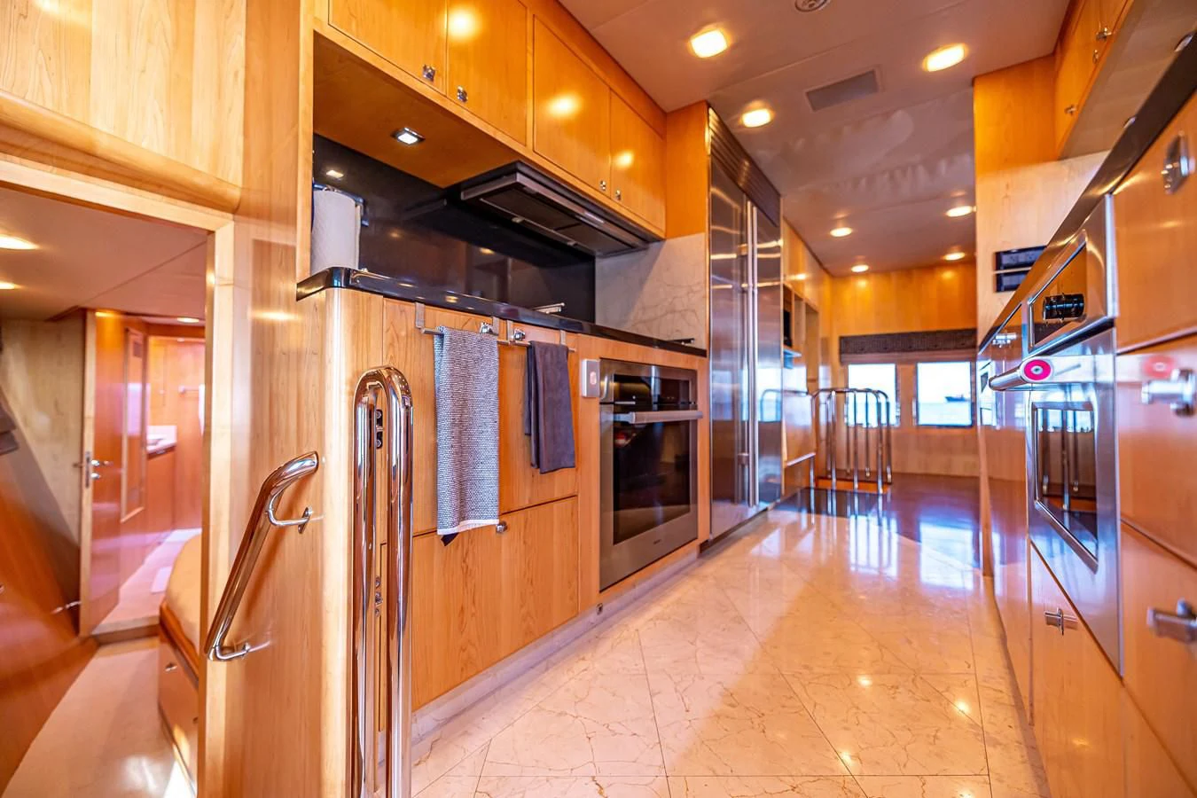 a kitchen with wooden cabinets aboard SALVATORE II Yacht for Sale