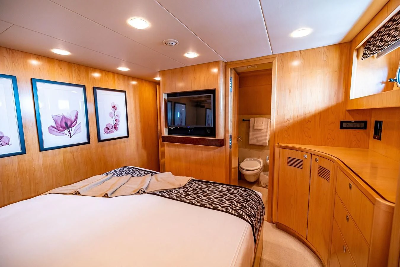 a bedroom with a bed and a television aboard SALVATORE II Yacht for Sale