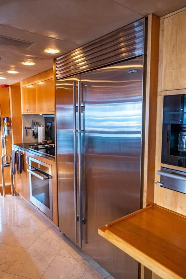 a stainless steel refrigerator in a kitchen aboard SALVATORE II Yacht for Sale