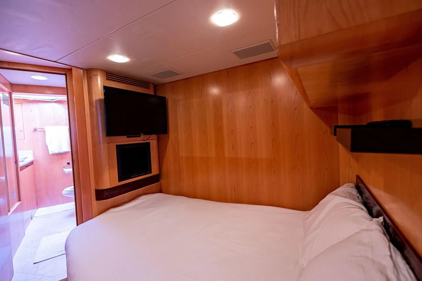 a bedroom with a wood wall aboard SALVATORE II Yacht for Sale