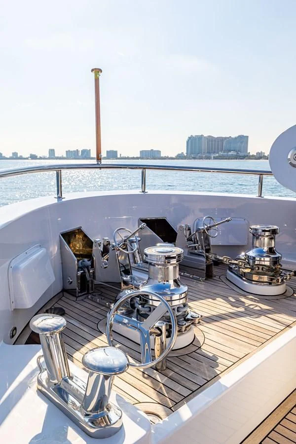 a group of metal pipes on a deck with water and cityscape in the background aboard SALVATORE II Yacht for Sale