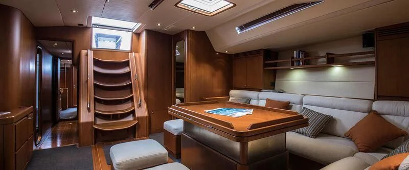 a room with a bed and a couch aboard ARIA Yacht for Charter
