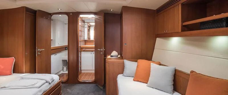 a room with a bed and a mirror aboard ARIA Yacht for Charter
