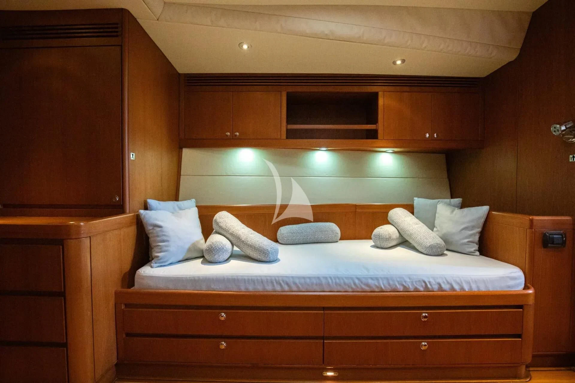 a bed with pillows aboard ARIA Yacht for Charter