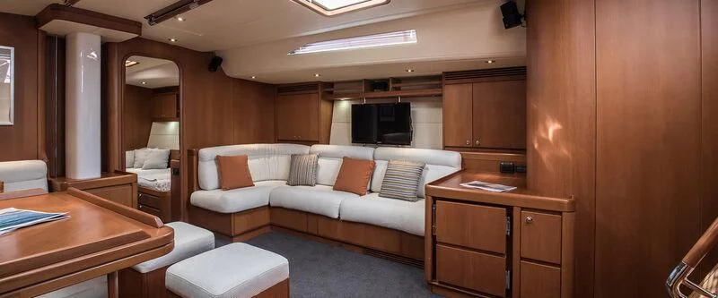 a room with a bed and a table aboard ARIA Yacht for Charter