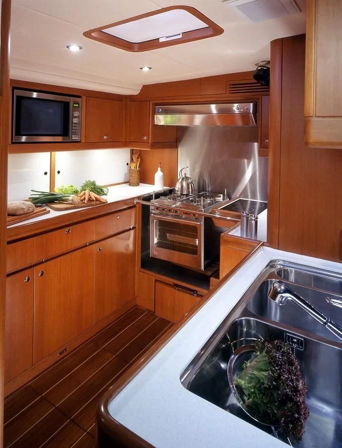 a kitchen with wooden cabinets aboard ARIA Yacht for Charter