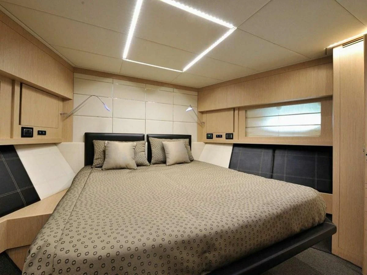 a room with a bed and a window aboard AUSTIN PARKER - 72 FLY Yacht for Sale
