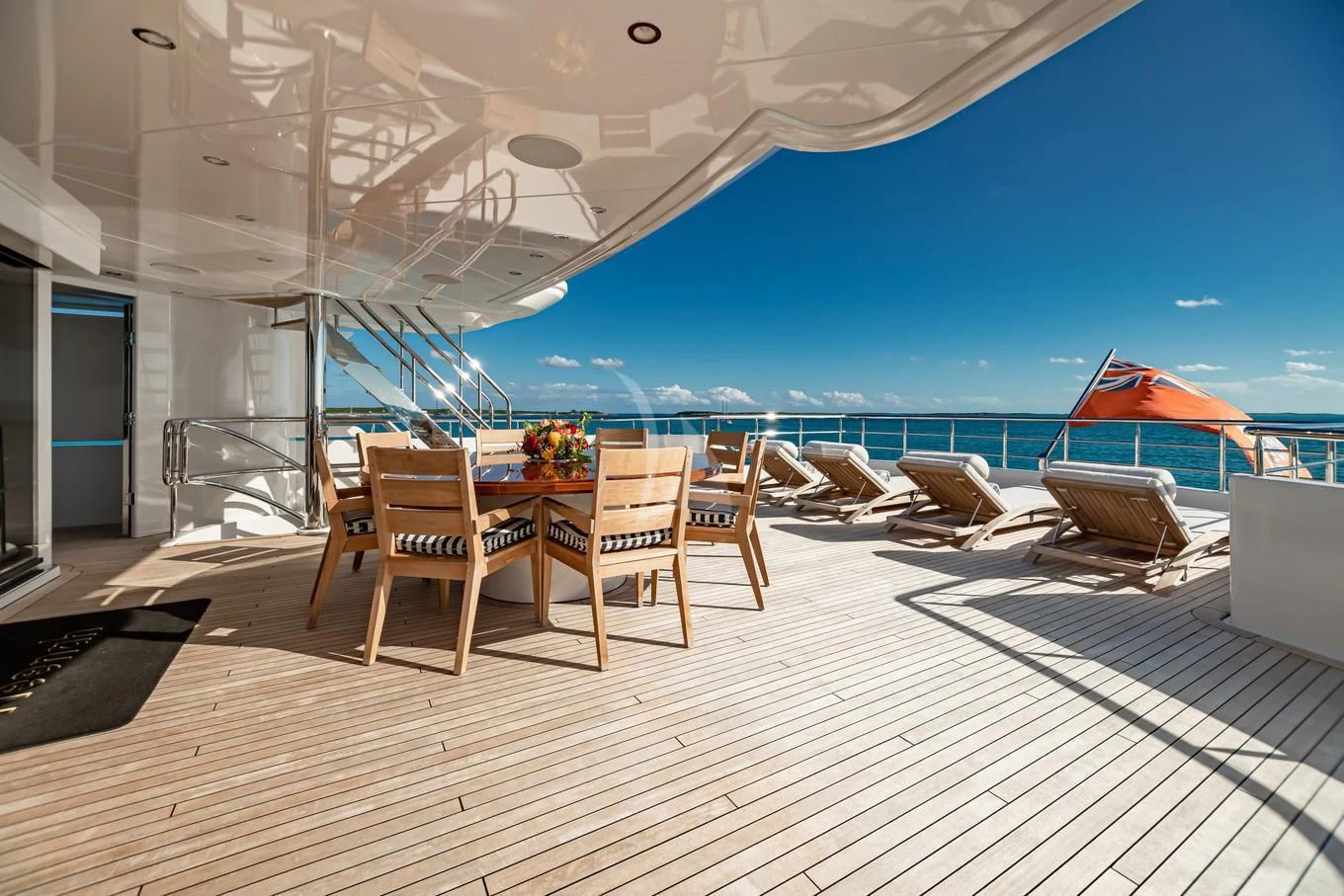 a deck with chairs and tables on it aboard NEENAH Yacht for Charter
