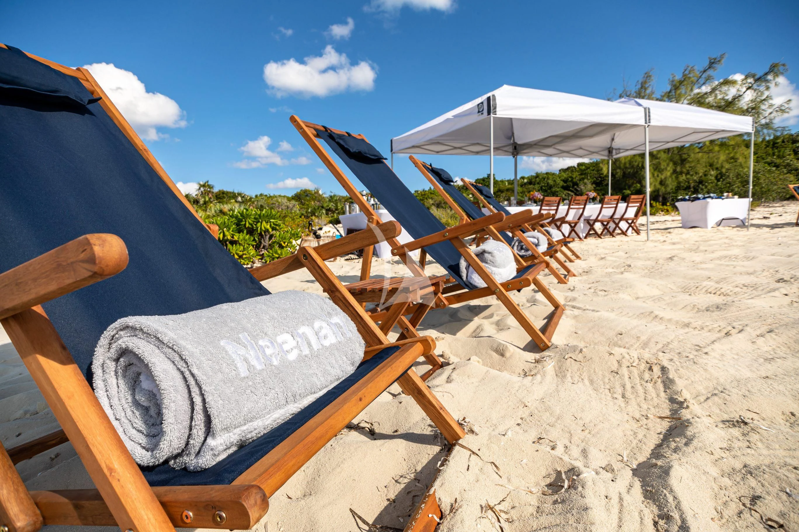 chairs and umbrellas on a beach aboard NEENAH Yacht for Charter
