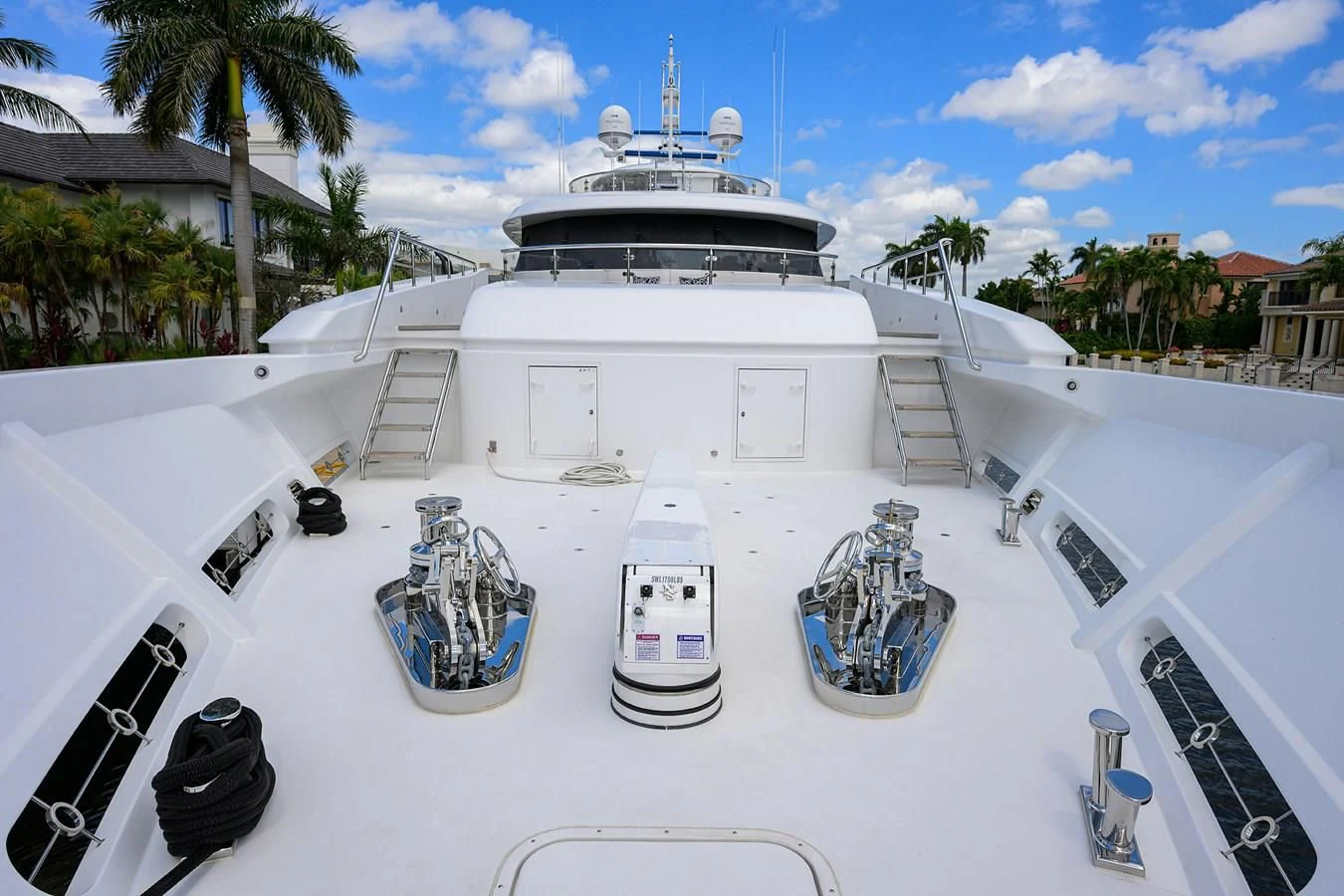 a white boat with a deck and a bicycle on a white surface aboard NEENAH Yacht for Charter