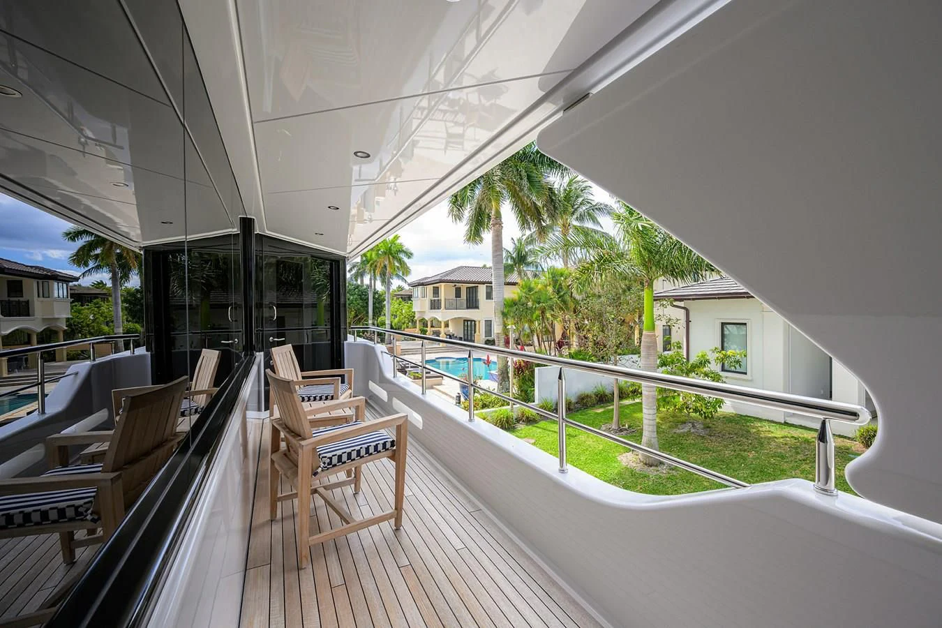 a deck with chairs and trees aboard NEENAH Yacht for Charter