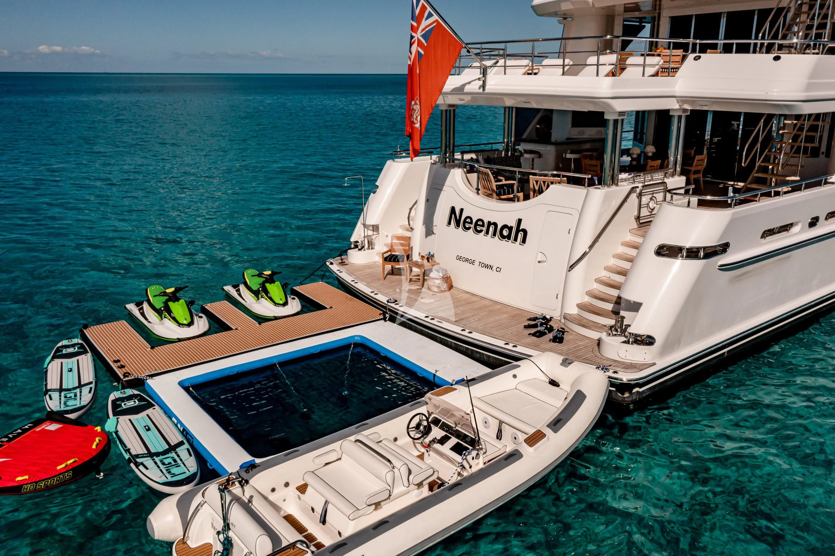 a boat with a flag on the side aboard NEENAH Yacht for Charter