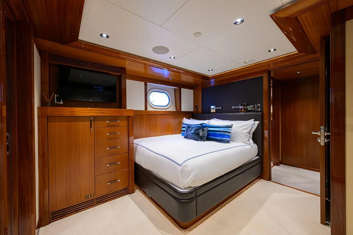 a bedroom with a bed and a tv aboard NEENAH Yacht for Charter