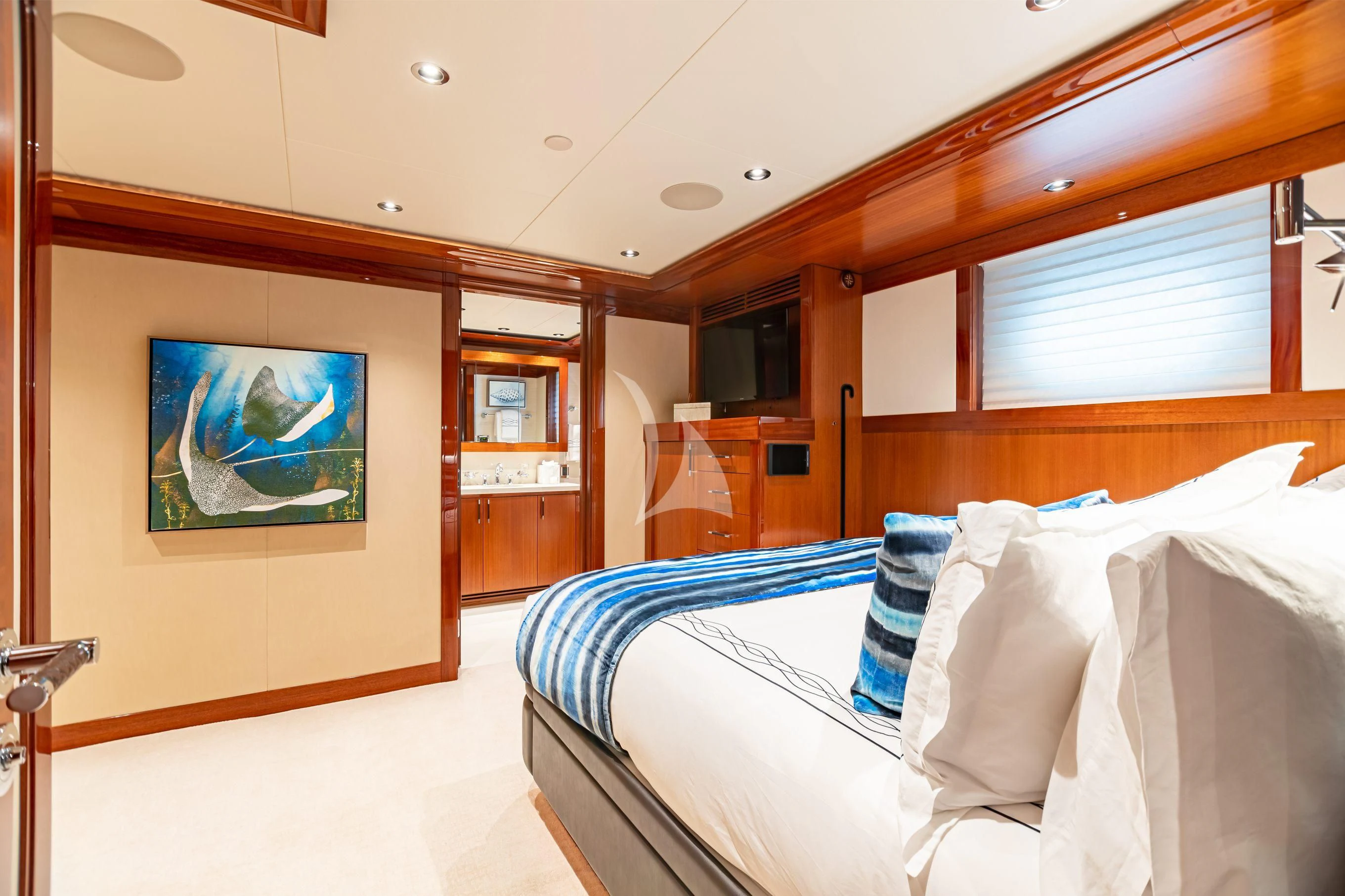 a room with a bed and a painting on the wall aboard NEENAH Yacht for Charter