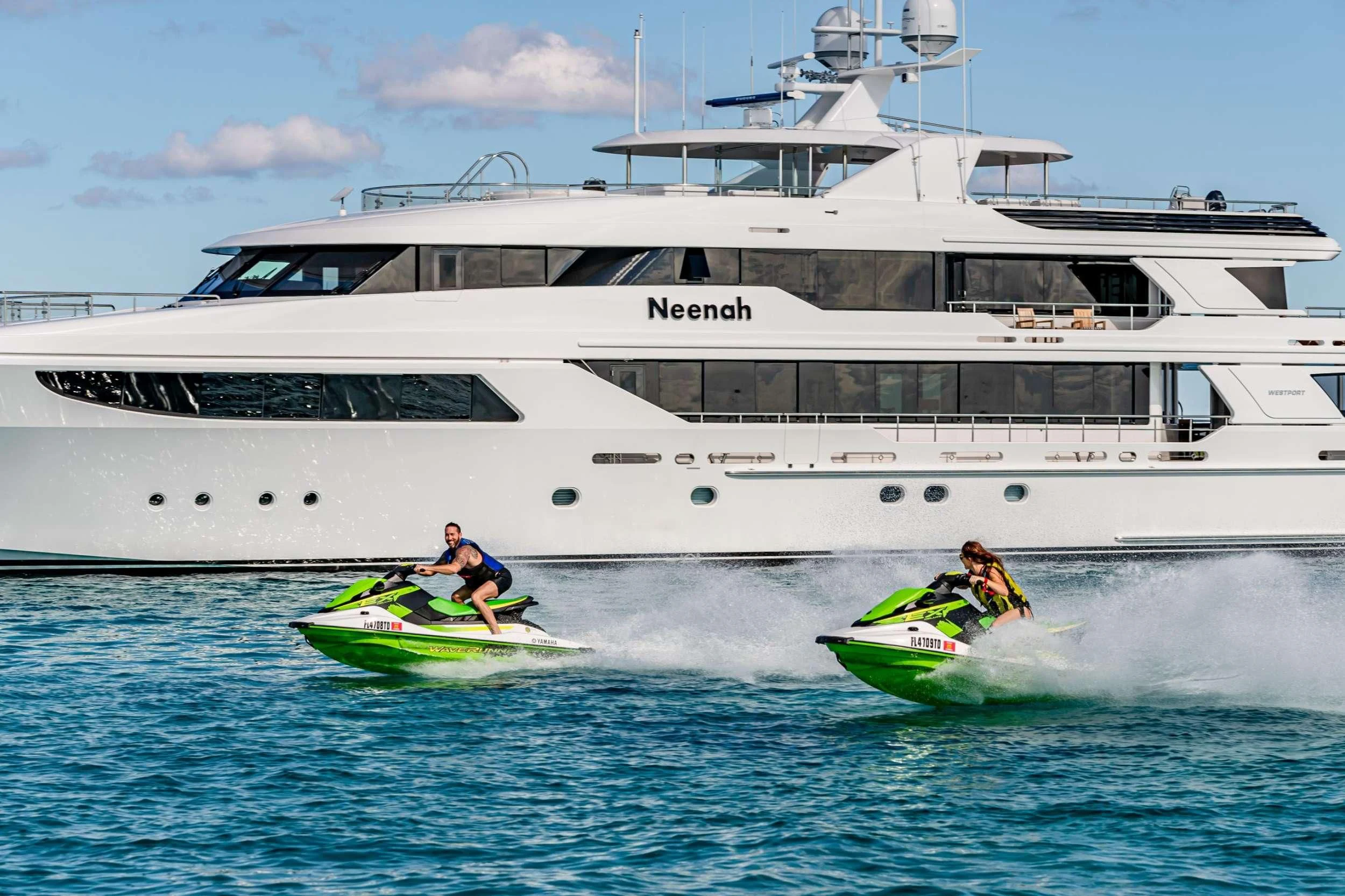 a boat with a motor boat in the background aboard NEENAH Yacht for Charter