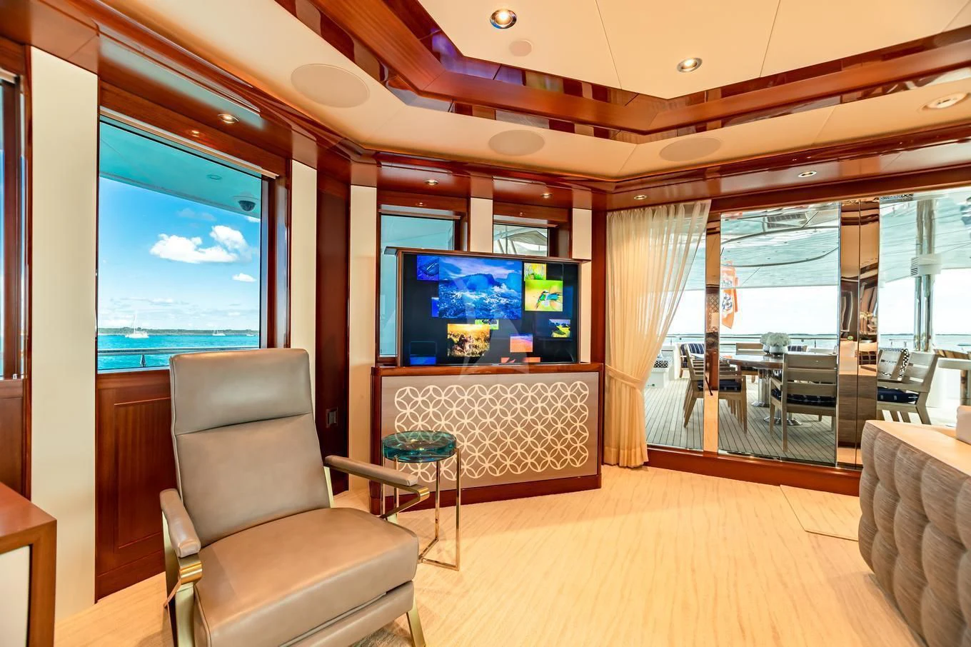 a living room with a large screen aboard NEENAH Yacht for Charter