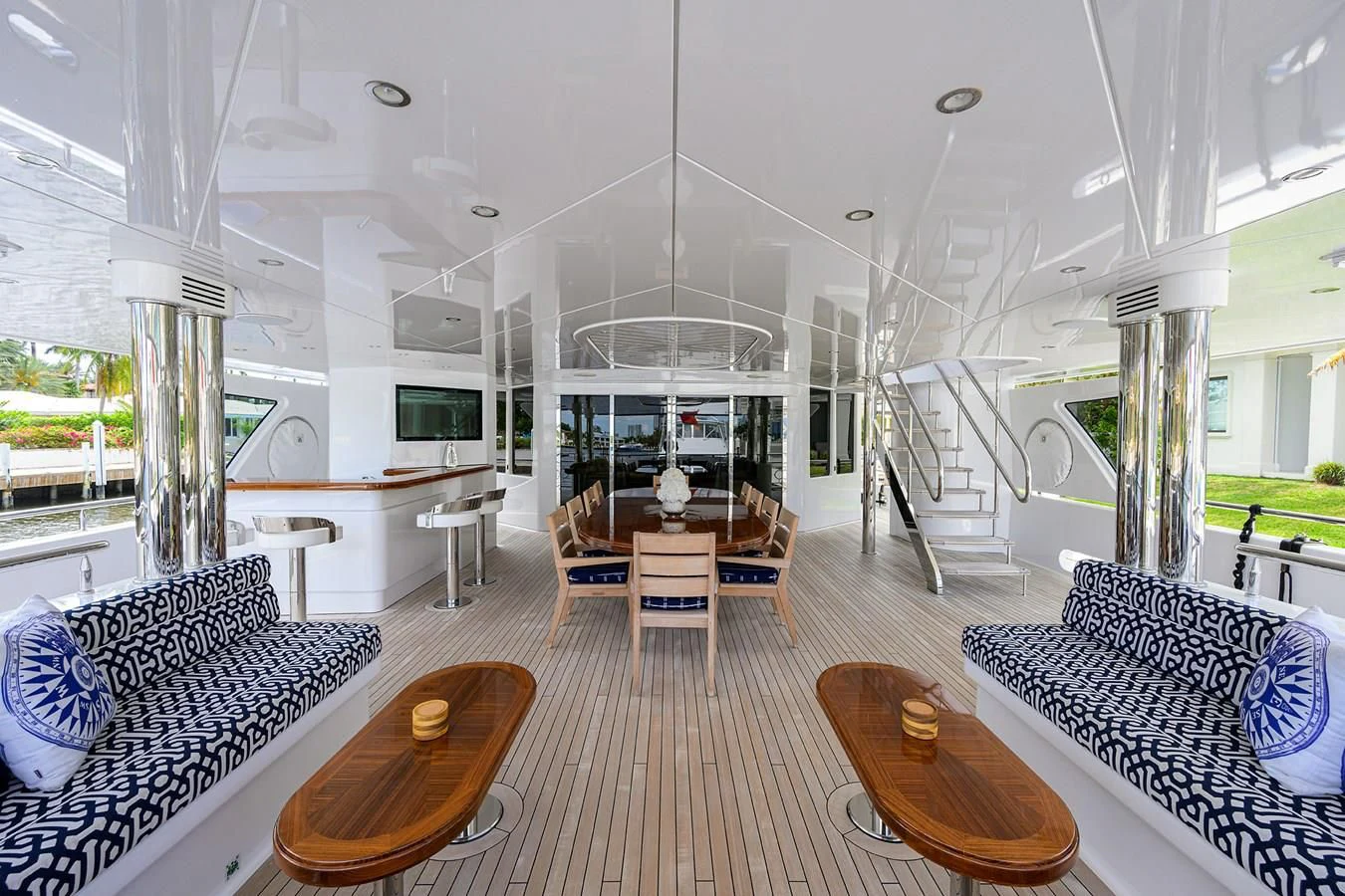 a large living room with a wood table and chairs aboard NEENAH Yacht for Charter