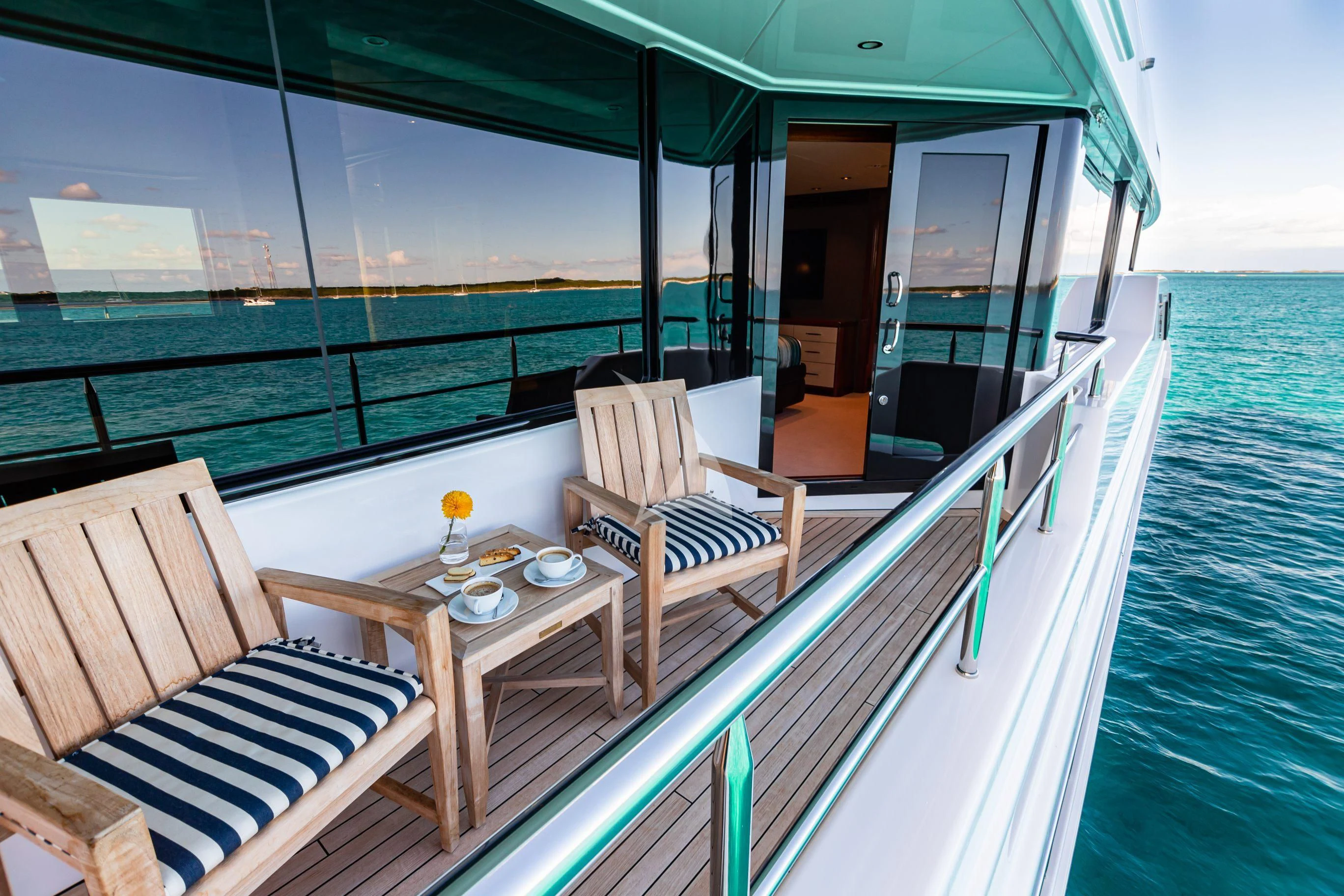 a balcony with a table and chairs on it aboard NEENAH Yacht for Charter