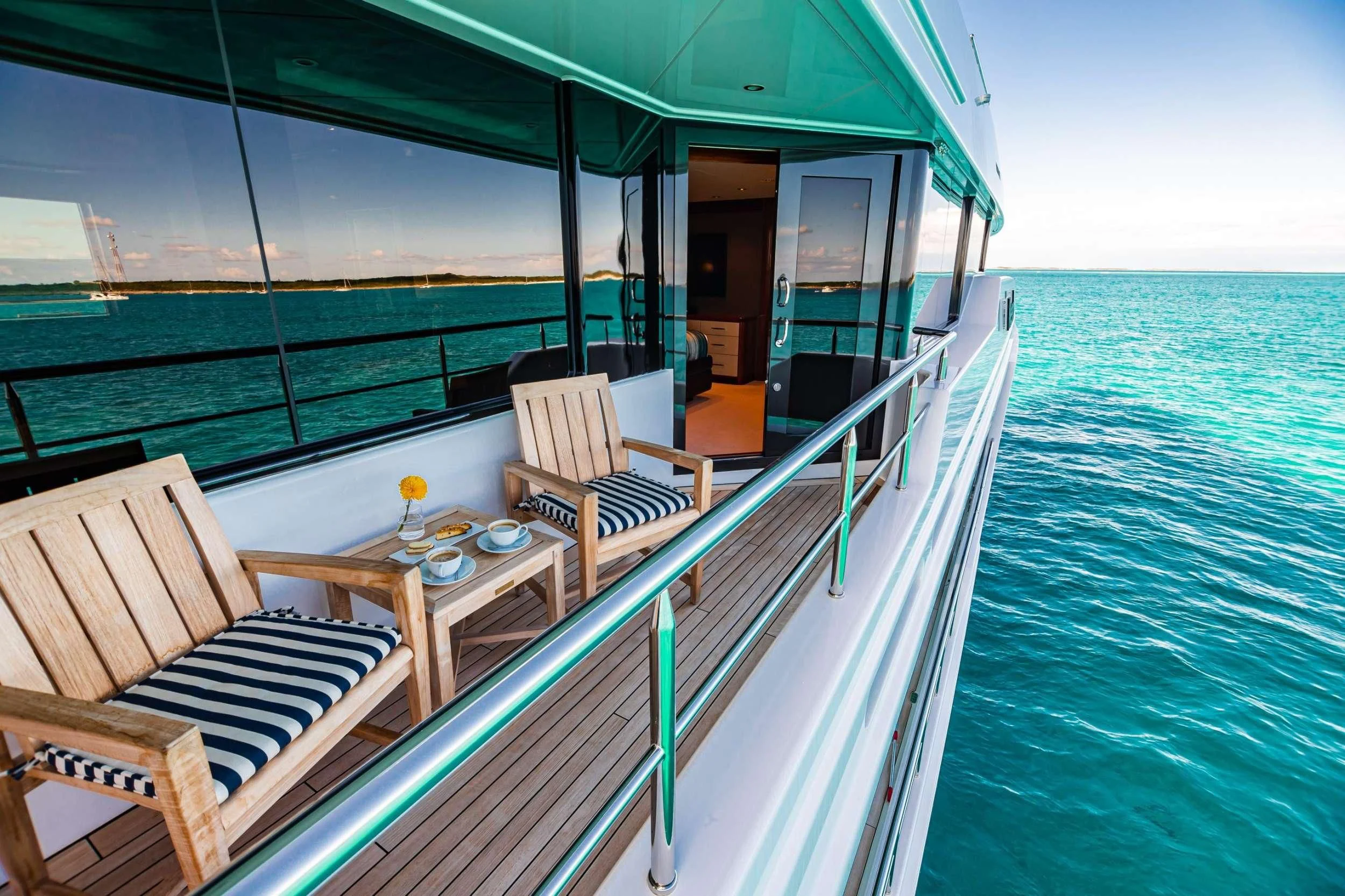 a deck with chairs and a table on it aboard NEENAH Yacht for Charter