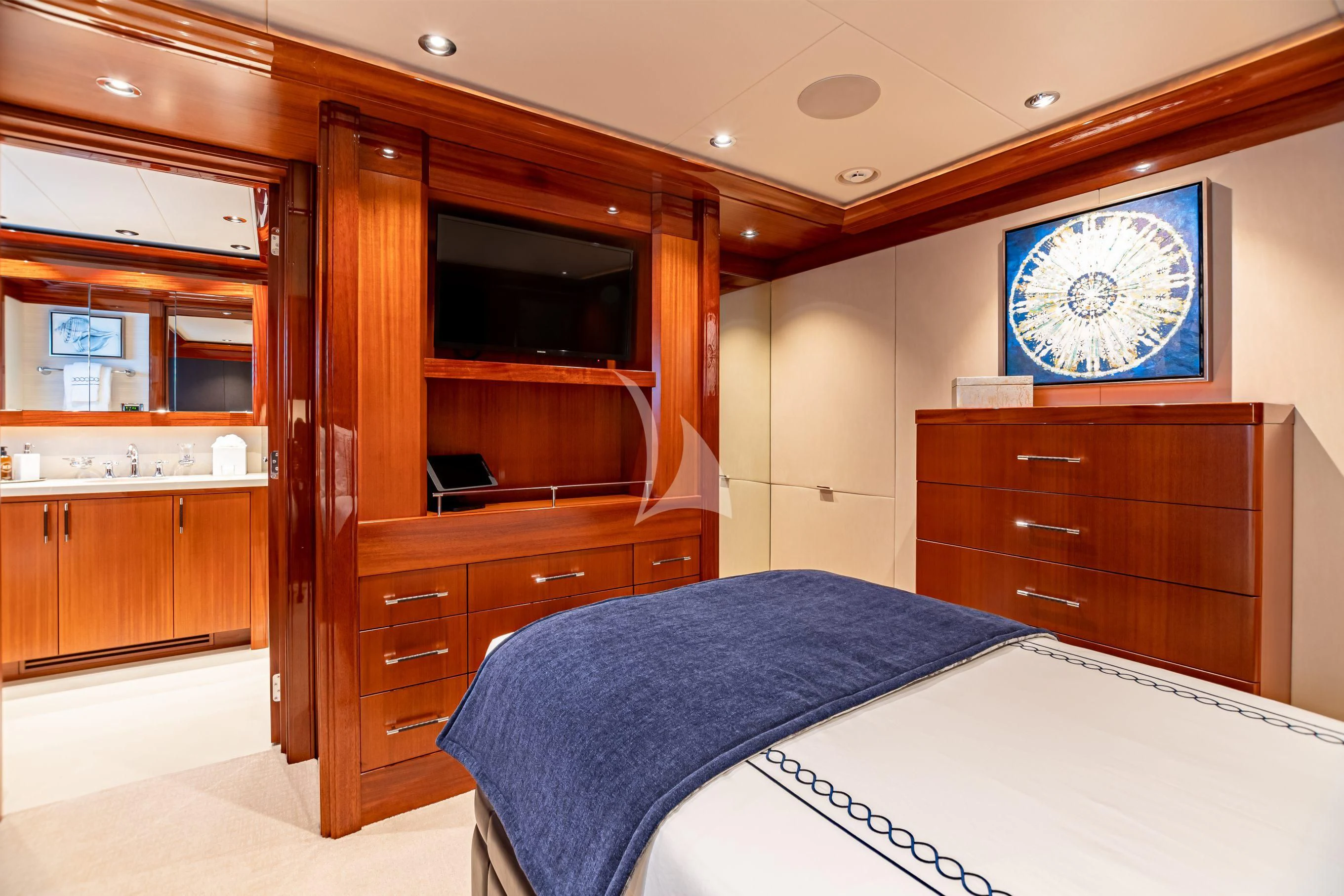a bedroom with a bed and a tv aboard NEENAH Yacht for Charter