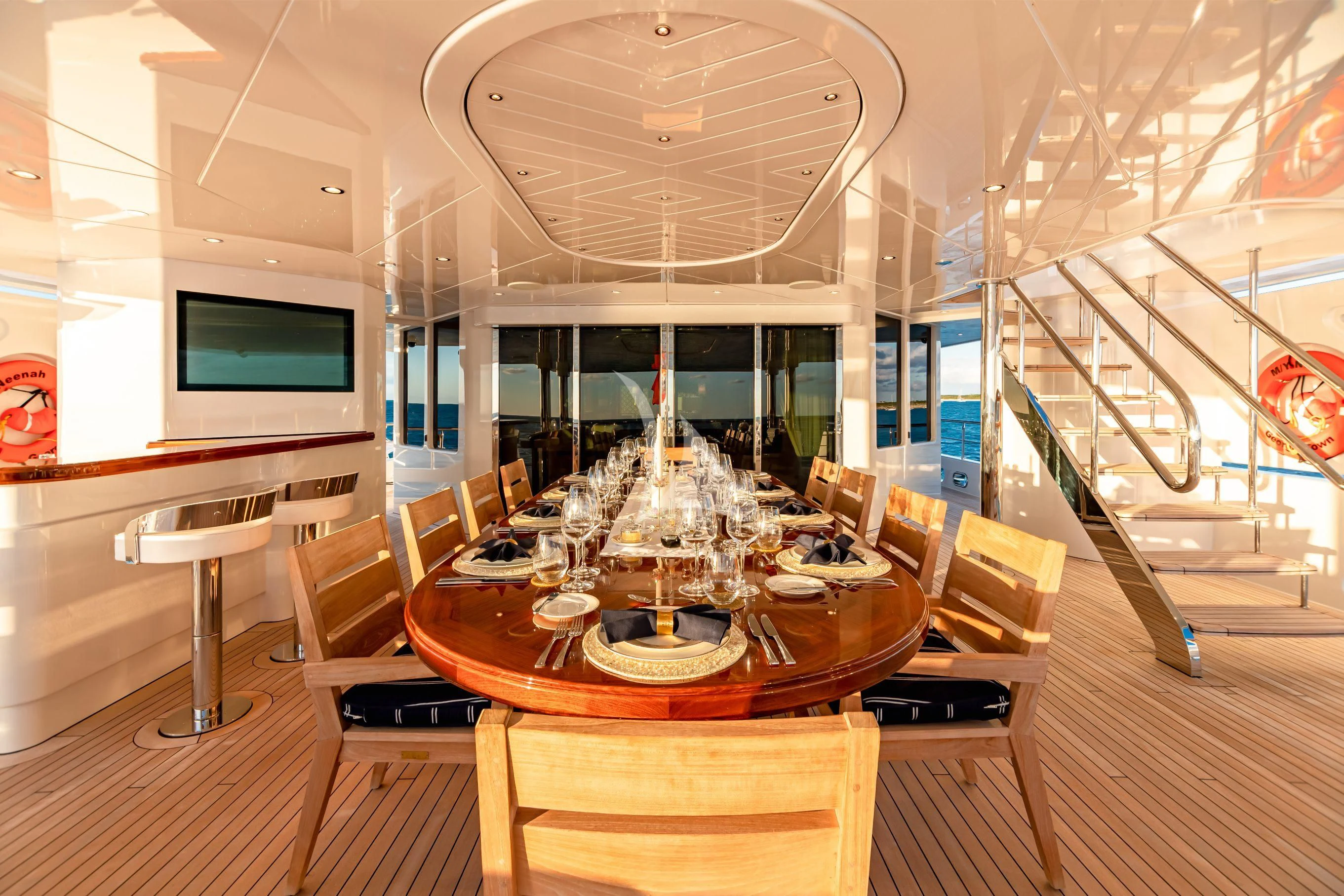 a room with a large chandelier and a table aboard NEENAH Yacht for Charter