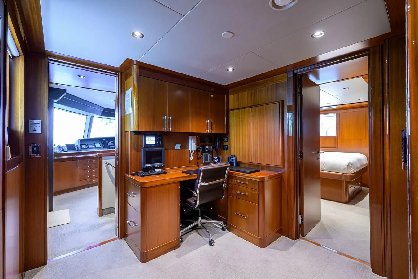 a room with a desk and a bed aboard NEENAH Yacht for Charter