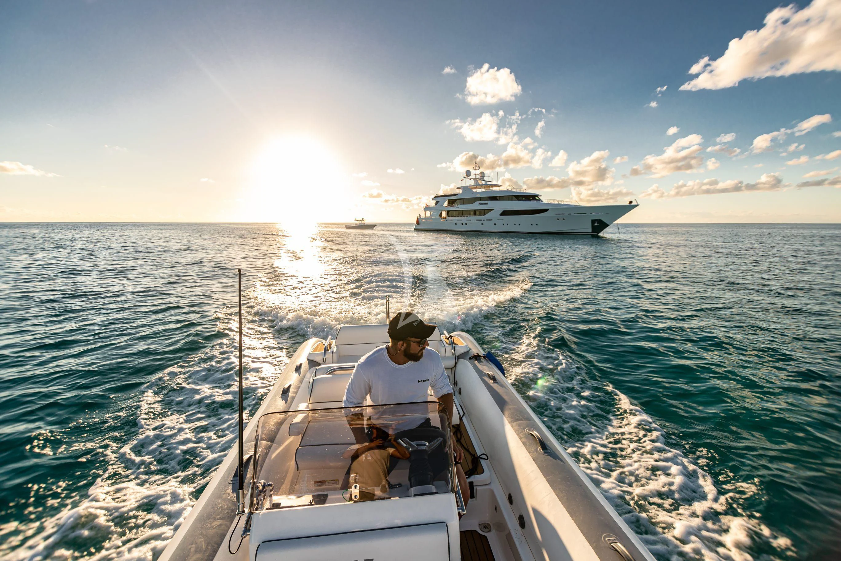 a person driving a boat on the water aboard NEENAH Yacht for Charter