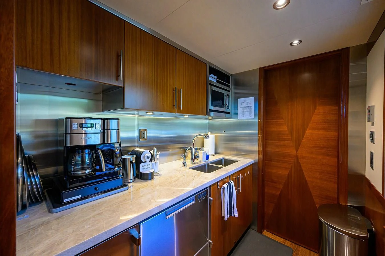 a kitchen with wooden cabinets aboard NEENAH Yacht for Charter