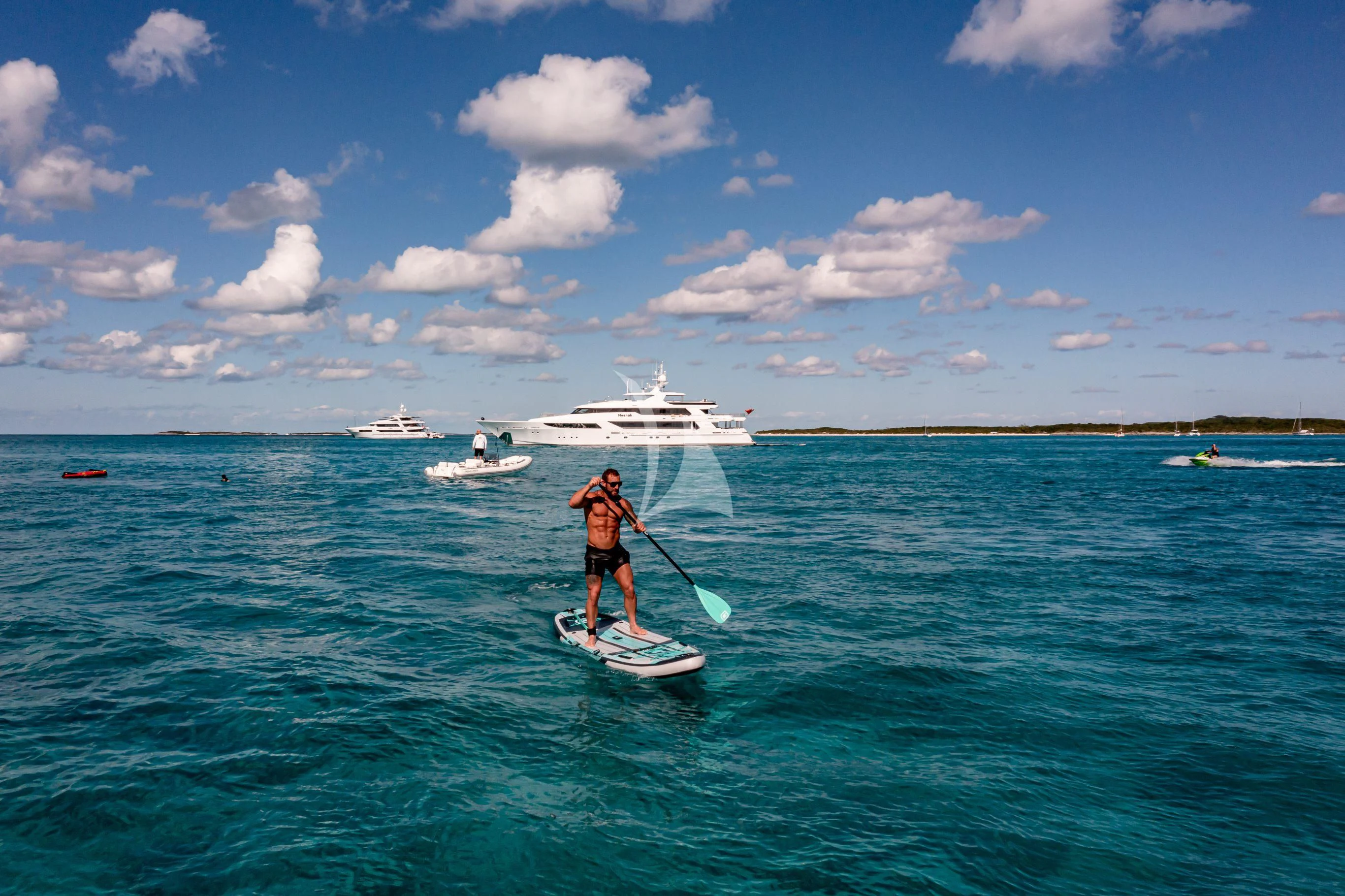 a man on a surfboard in the ocean aboard NEENAH Yacht for Charter