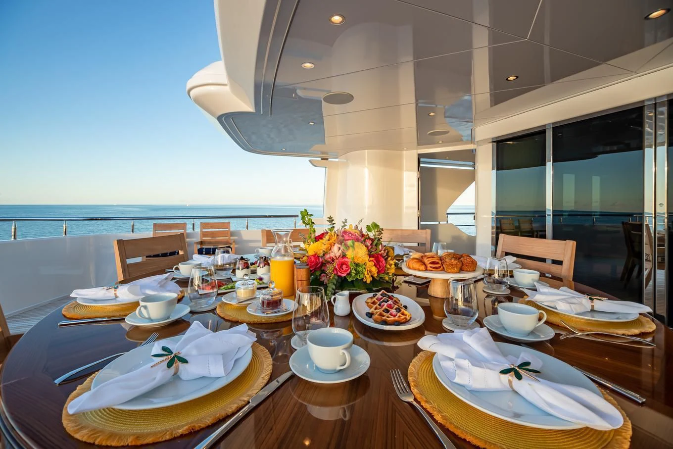 a table with plates and cups on it aboard NEENAH Yacht for Charter