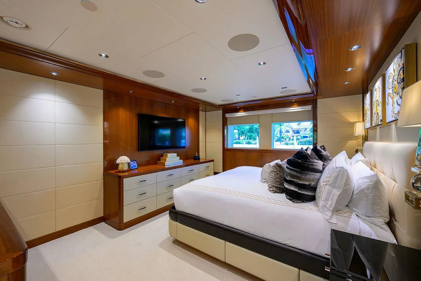a bedroom with a bed and a tv aboard NEENAH Yacht for Charter