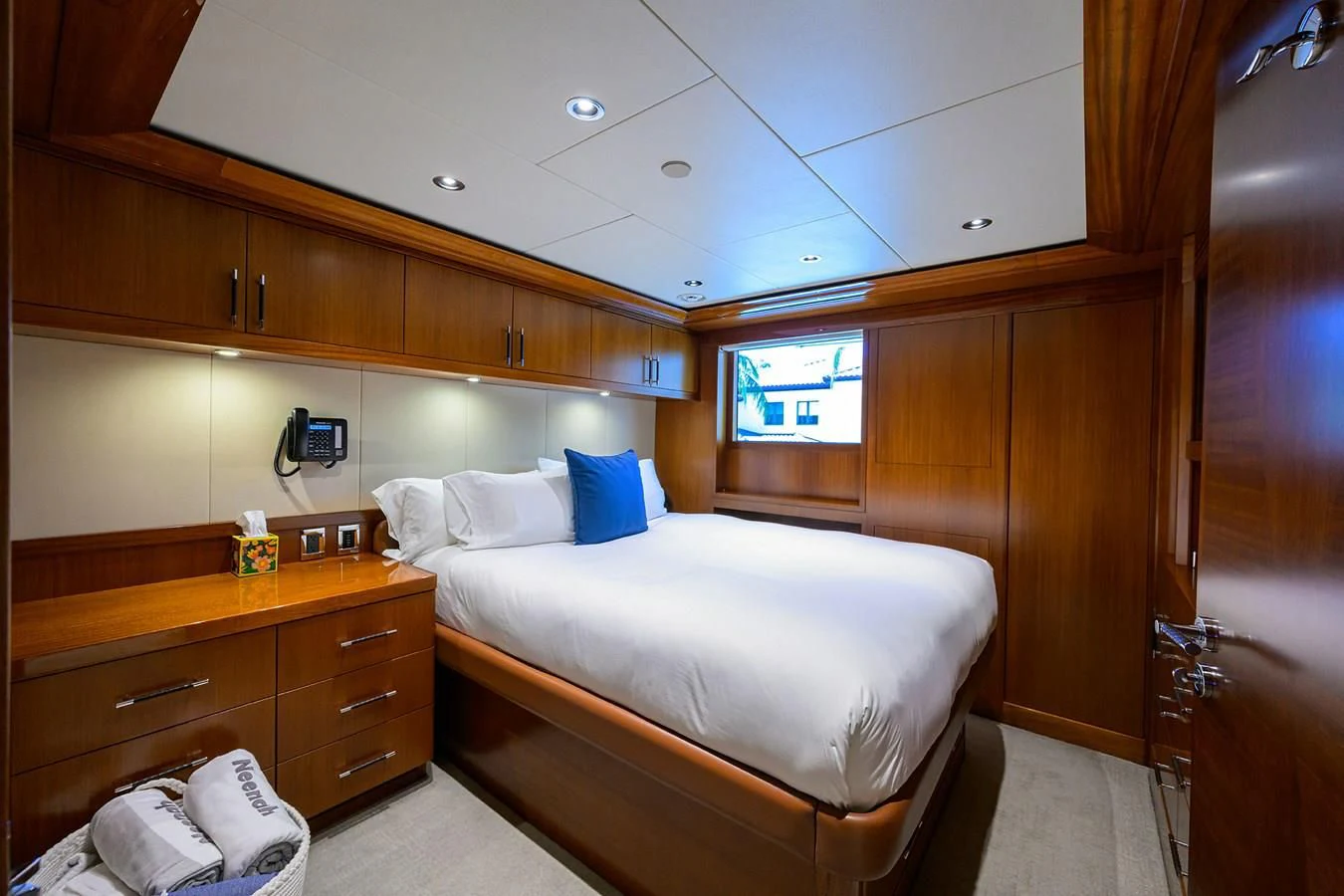 a room with a bed and a dresser aboard NEENAH Yacht for Charter