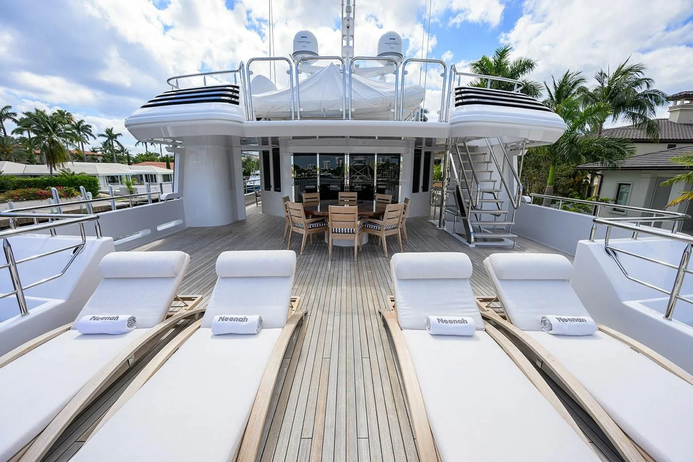 a deck with a deck and chairs aboard NEENAH Yacht for Charter