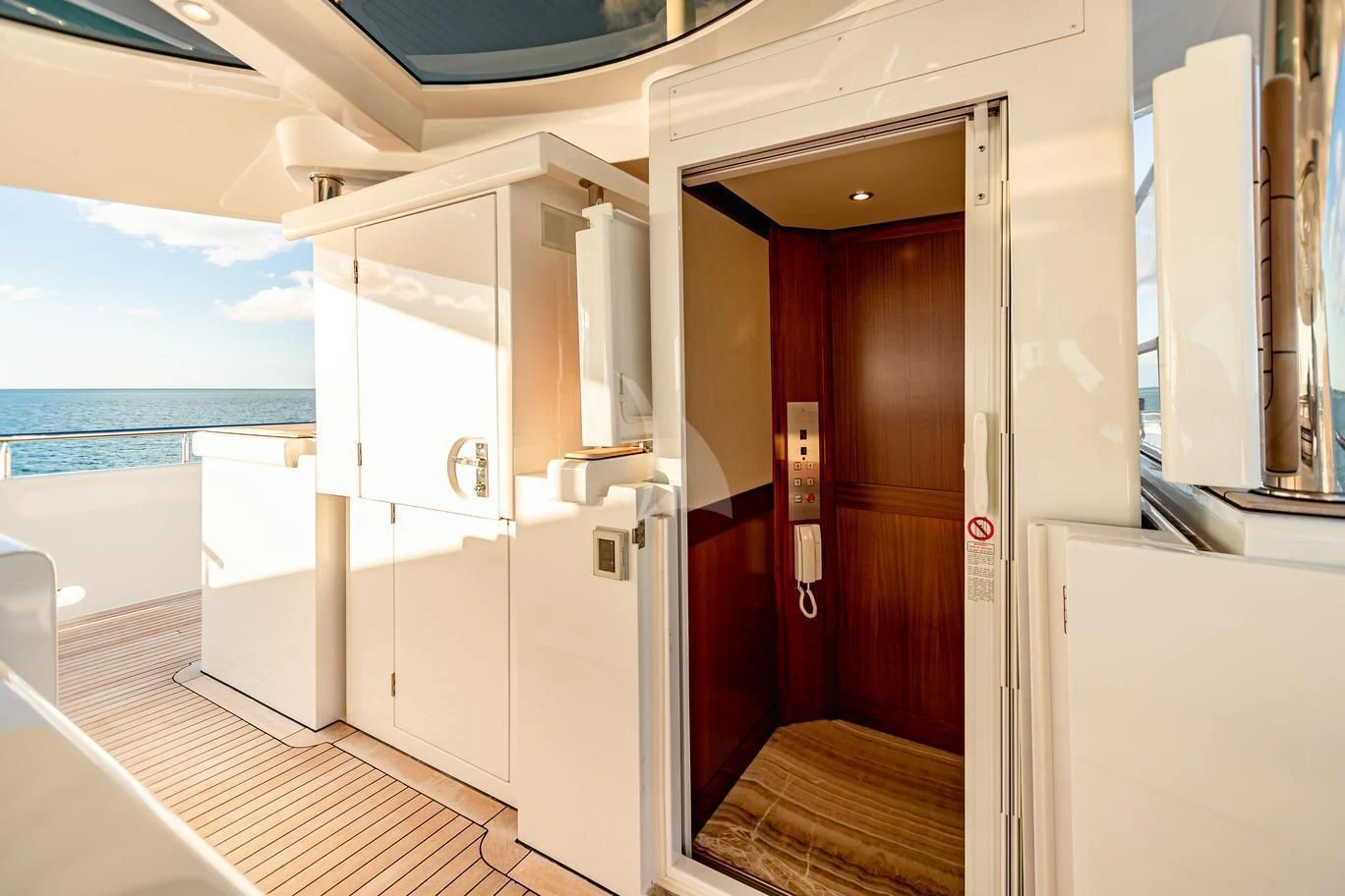 a room with a balcony and a view of the ocean aboard NEENAH Yacht for Charter