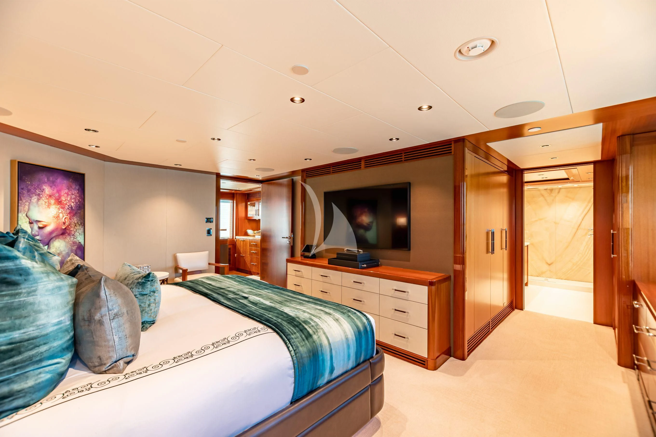 a bedroom with a bed and a television aboard NEENAH Yacht for Charter