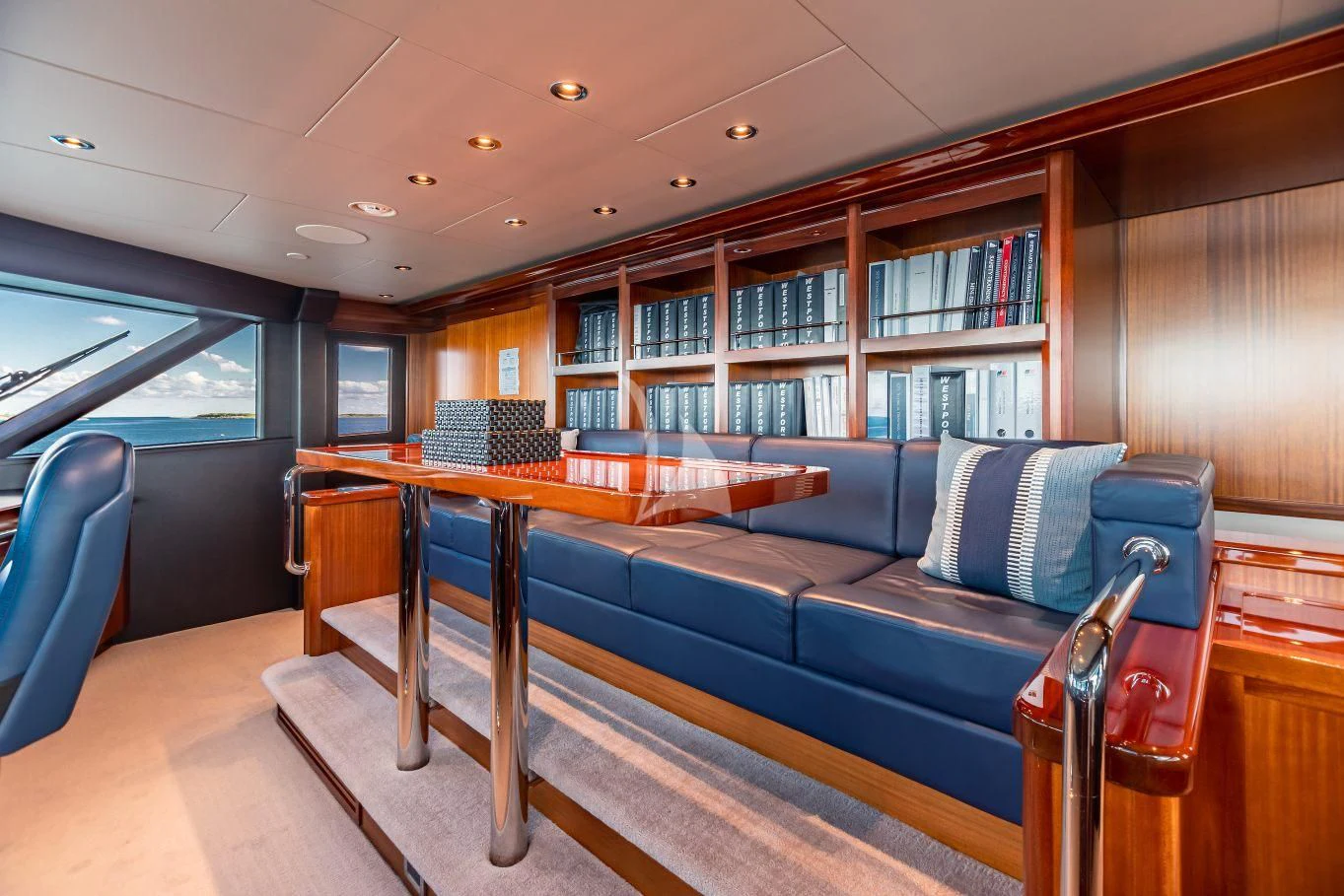 a couch in a library aboard NEENAH Yacht for Charter