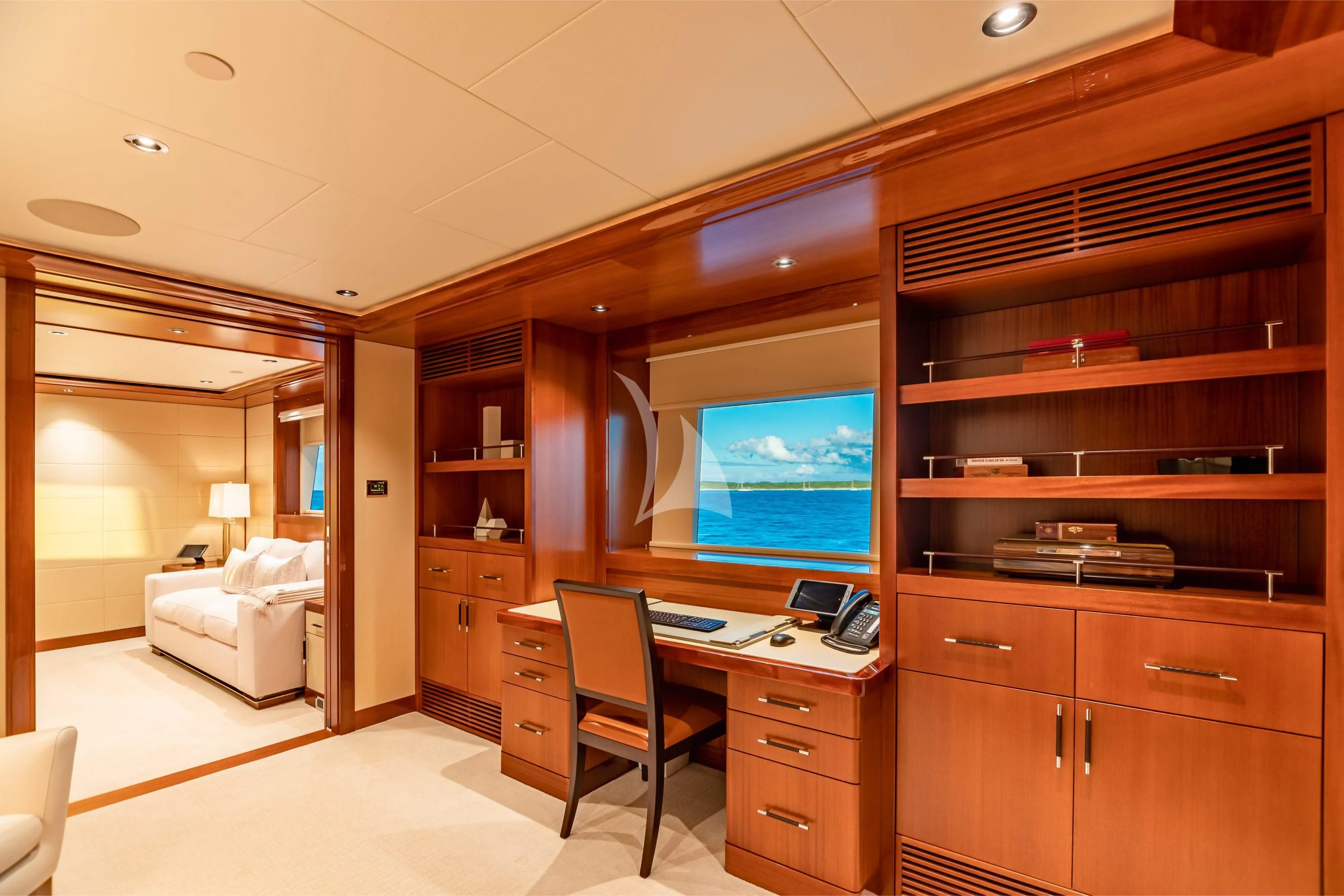 a room with a desk and a tv aboard NEENAH Yacht for Charter