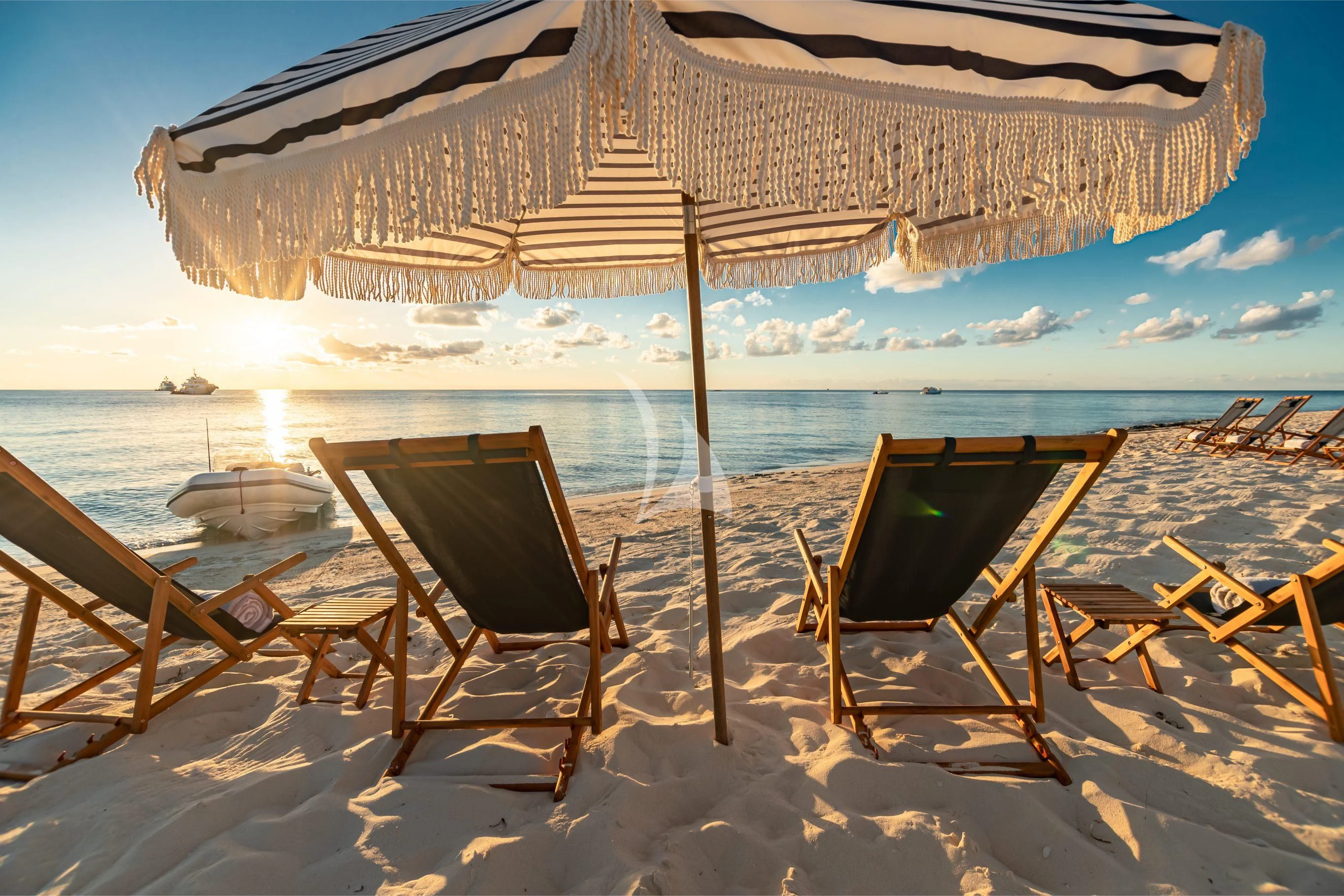 a beach with chairs and umbrellas aboard NEENAH Yacht for Charter