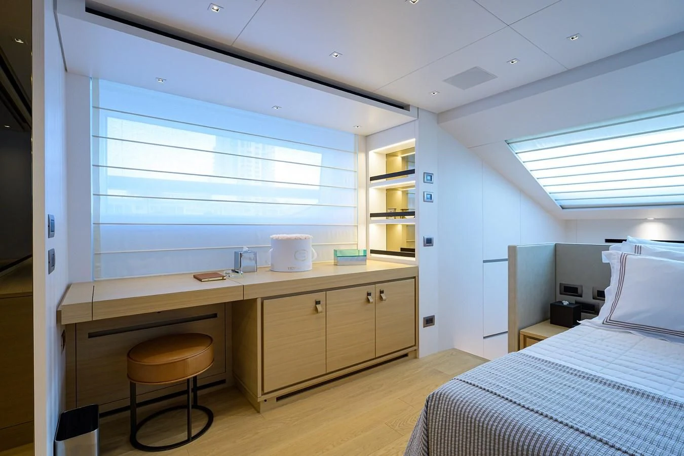 a bedroom with a desk and a bed aboard GATSBY Yacht for Charter