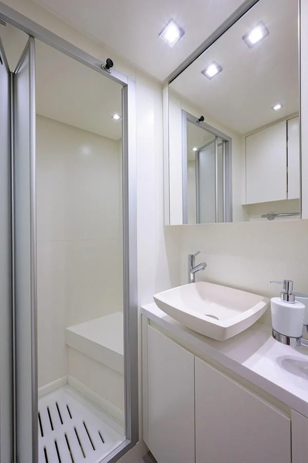 a bathroom with a sink and a shower unit aboard GATSBY Yacht for Charter