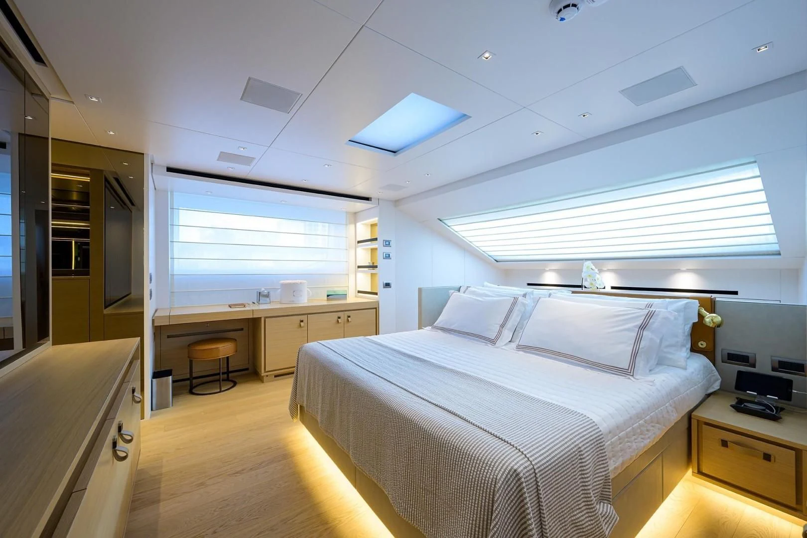 a bedroom with a bed and desk aboard GATSBY Yacht for Charter