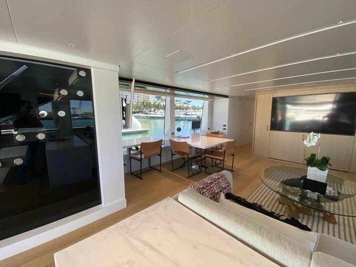 a living room with a large window aboard GATSBY Yacht for Charter