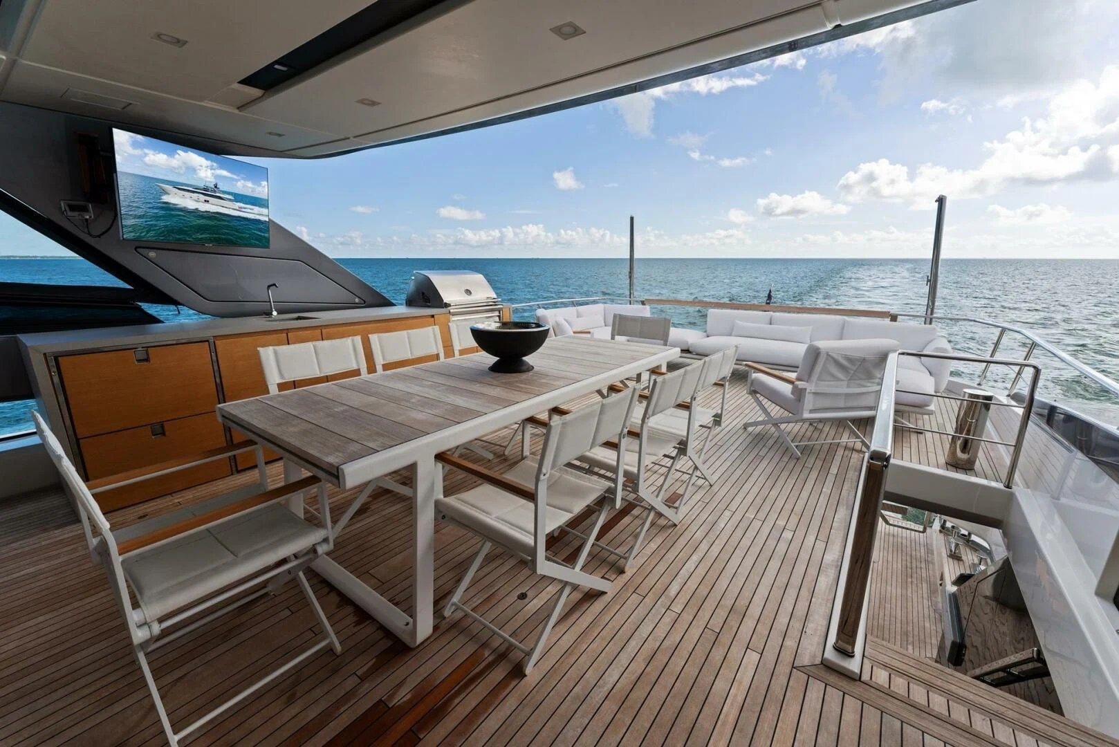 a deck with a table and chairs on it aboard GATSBY Yacht for Charter