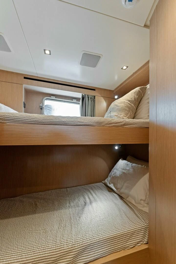 a bed with a microwave above it aboard GATSBY Yacht for Charter
