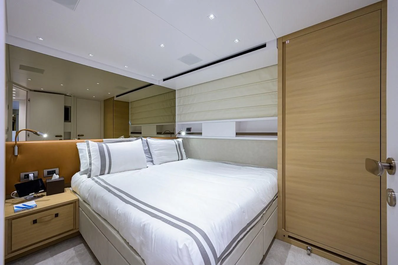 a room with a bed and a closet aboard GATSBY Yacht for Charter