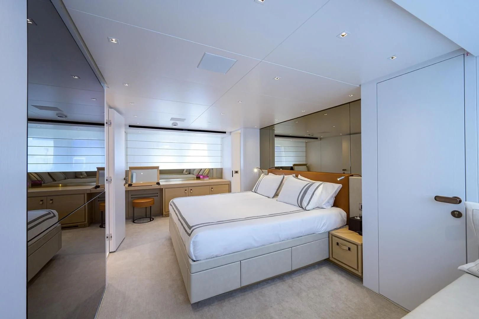 a bedroom with a bed and desk aboard GATSBY Yacht for Charter